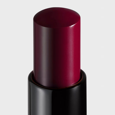 The New Vamp deep plum lipstick product shot close up. Moisturizing, nourishing, hydrating, antioxidant-rich, and botanical-infused formula.