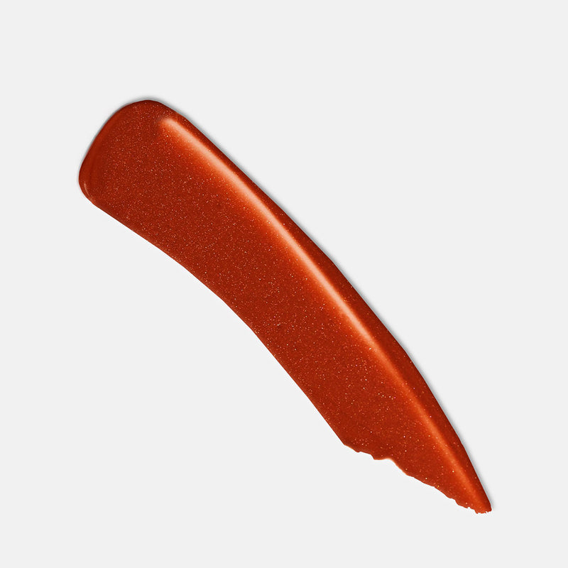 Public burnt orange shimmer lipstick product shot. Moisturizing, nourishing, hydrating, antioxidant-rich, and botanical-infused formula.