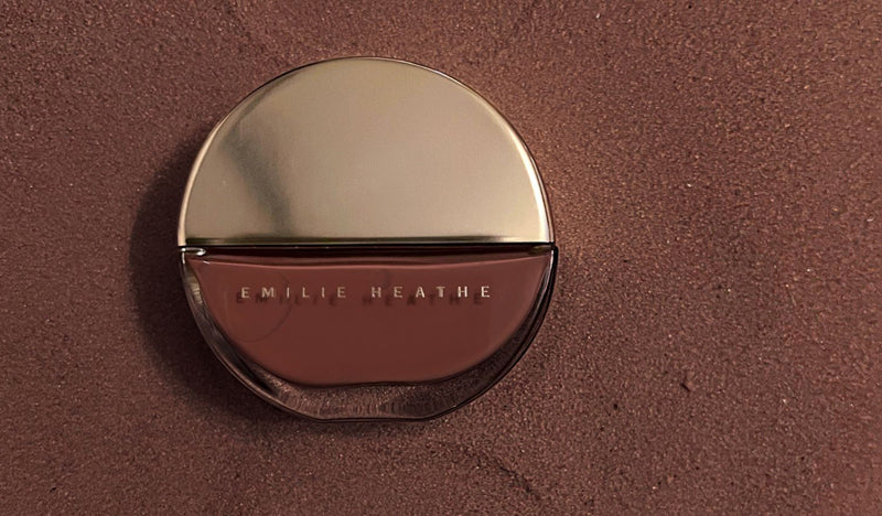 Petra Nail Artist Nail Polish laid on top of brown sand.